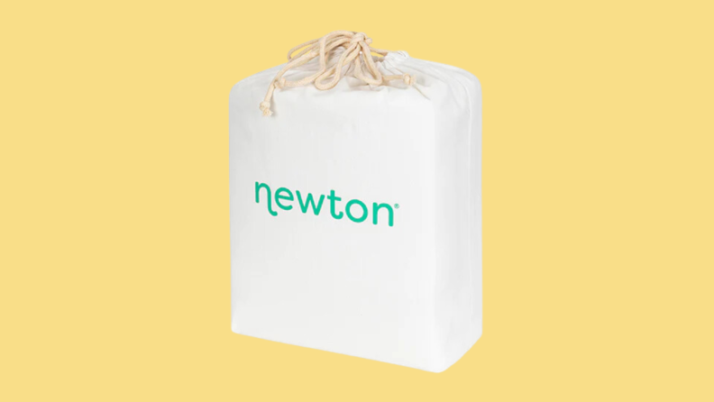 A Newton waterproof mattress pad, still in the packaging, on a yellow background.