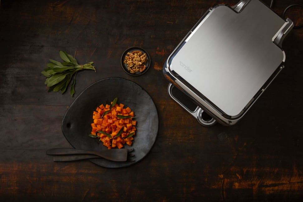 The Cinder Sensing Cooker next to a vegetable desk