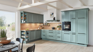 A beautiful, sunny kitchen with two walls of cabinets painted green