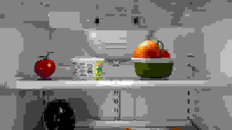 A close-up of the fridge's upper shelves, with some fresh fruits stored on them.