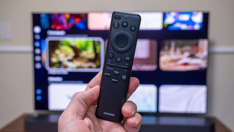 A remote control in front of A Samsung television screen with bright colors