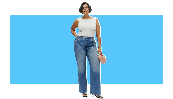 A model wearing a white tank with denim wide-leg jeans.