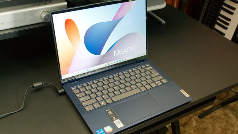 An open and powered on laptop showing a colorful image on its display