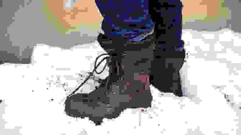 A man wears a pair of Kamik NationPlus Boots in the snow.
