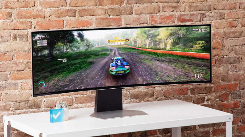 A super ultrawide, the Samsung Odyssey OLED G9 and out best gaming monitor upgrade pick, with a racing game on screen