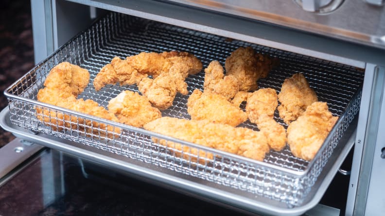 Crispy chicken inside an air fryer toaster oven