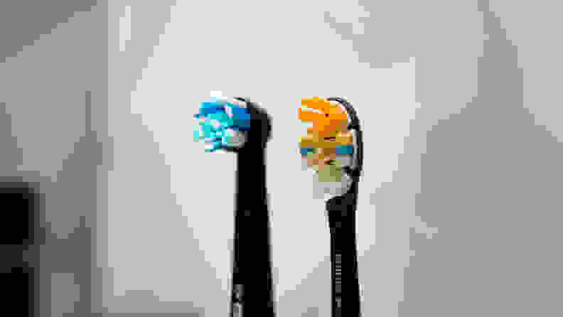 The brush heads of an Oral B and Philips Sonicare toothbrush placed side-by-side, in order to compare the differences between them.