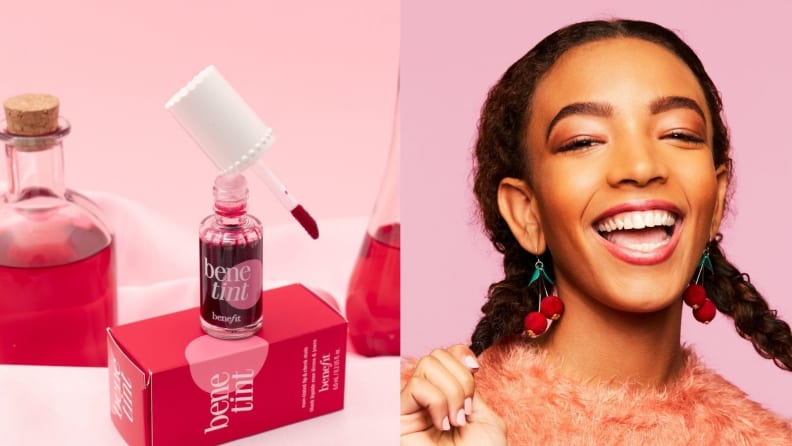 On the left: The Benefit Cosmetics Benetint Rose Lip & Cheek Tint stands with the applicator balanced on the jar of liquid product on top of the tint's cardboard packaging. On the right: A person smiles at the camera wearing pink-themed makeup, cherry earrings, and braids.