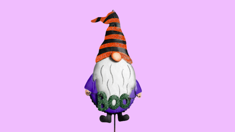 An image of a Halloween gnome in purple with a little sign that says 