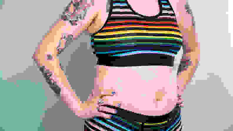 Close-up of stomach of person in TomboyX bra and TomboyX trunks.