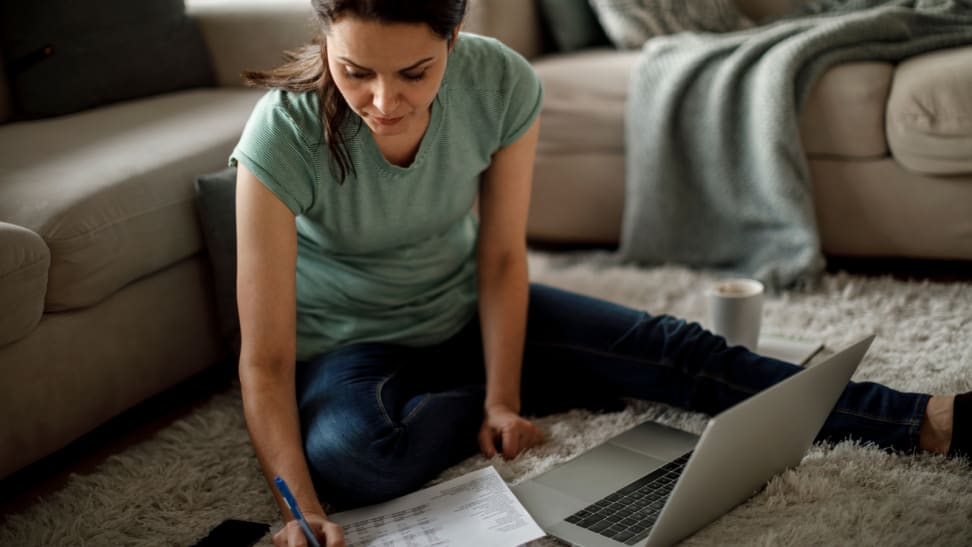 Woman doing her taxes on the floor