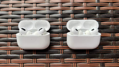 The white AirPods Pro case sits open next to the very similar AirPods Pro (2nd gen) case