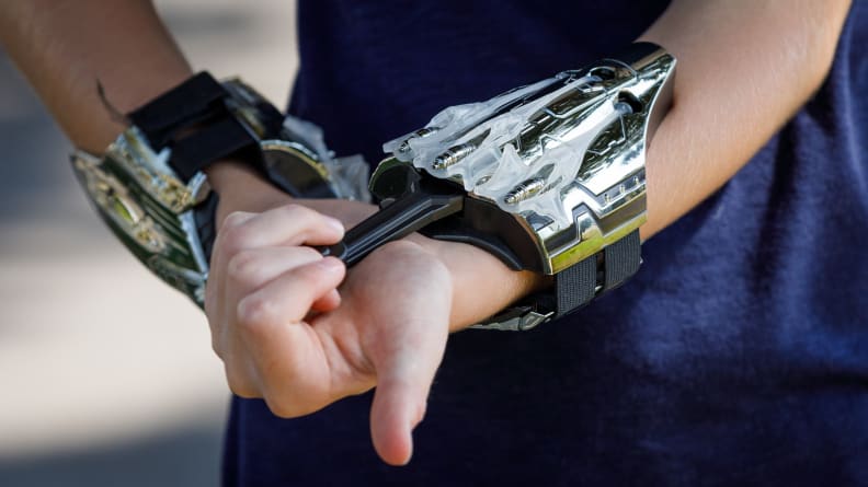 A child wrists wearing a pair of shopDisney Spider-Man web shooters.