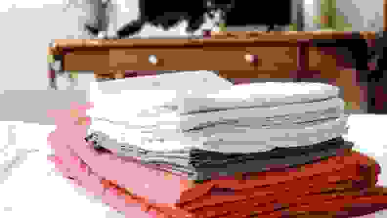 a stack of sheets on a bed