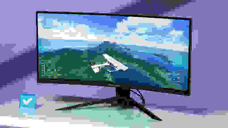Vibrant colors pop in the image of a plane flying over an island on the screen of an ASRock Phantom Gaming PG34WQ15R2B monitor.