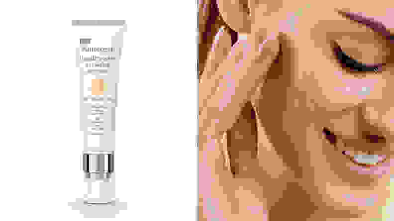 On the left, the Neutrogena Healthy Skin Anti-Aging Perfector in a light shade stands on a white background. On the right, a lighter-skinned woman looks down while sweeping the foundation across her cheek bone with her fingers.