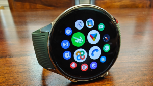 Close-up view of the OnePlus Watch 2 with app icons on display arranged in a circular pattern.
