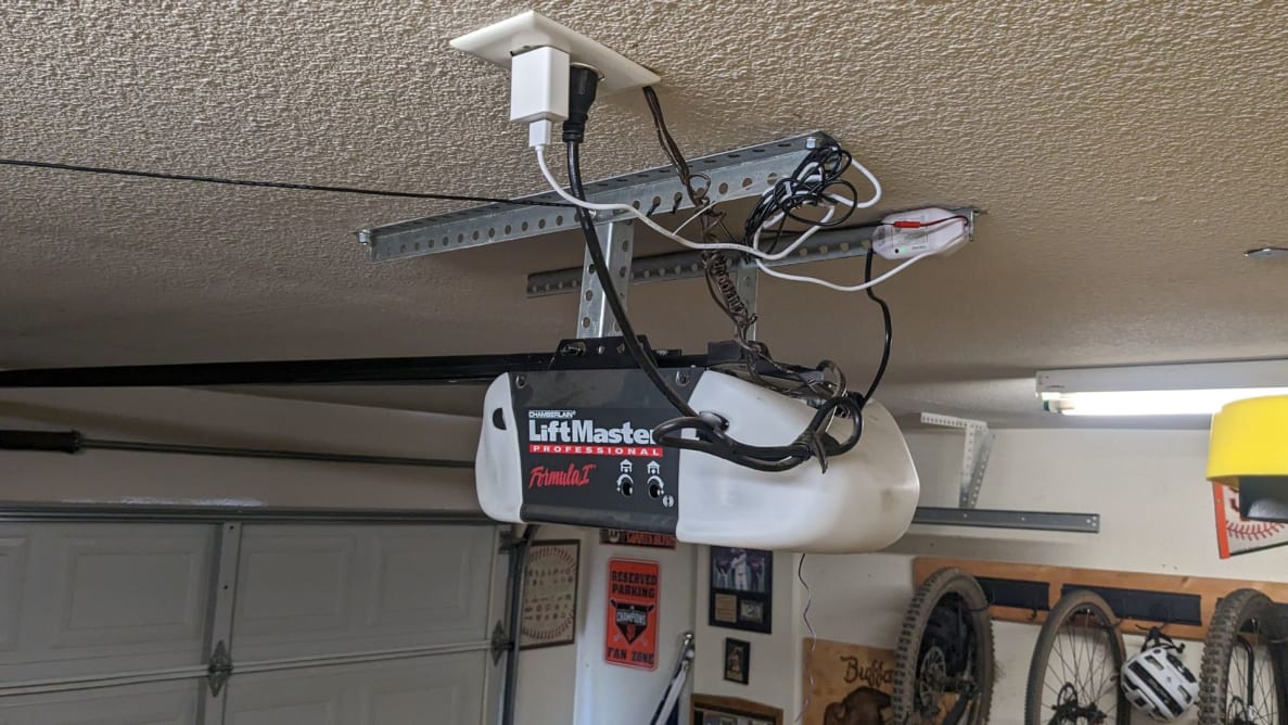 The Meross Garage Door Opener hanging in a residential garage.
