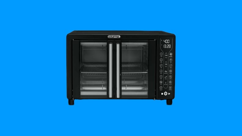 A Gourmia toaster oven against a blue background.