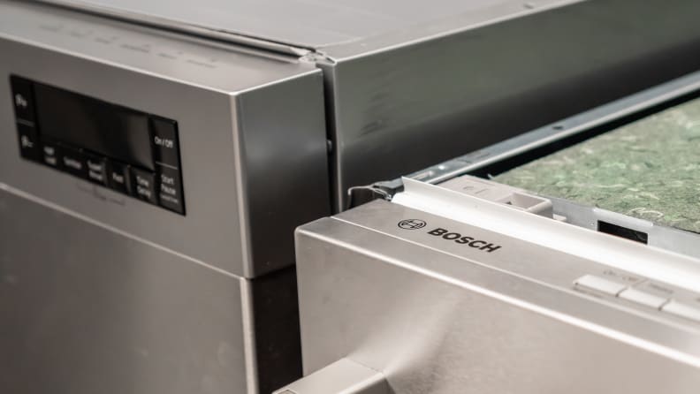 The Bosch dishwasher sits next to a standard-sized model, coming up about an inch shorter.