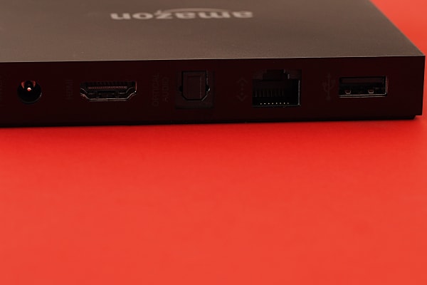 For ports, Fire TV includes a power input, an HDMI input, an optical audio output, an ethernet jack, and a USB port.