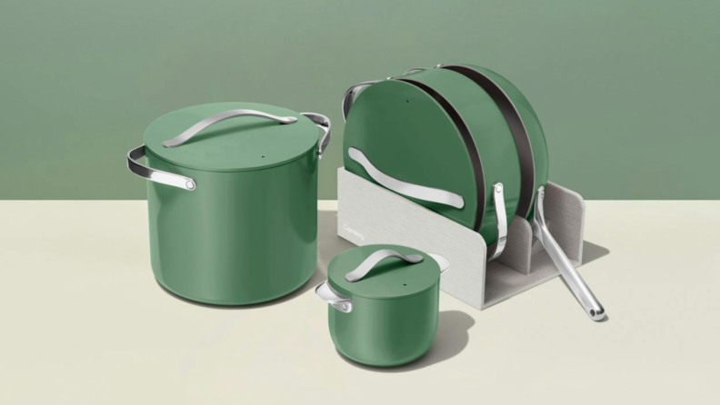A green Caraway cookware set on a white and green background.