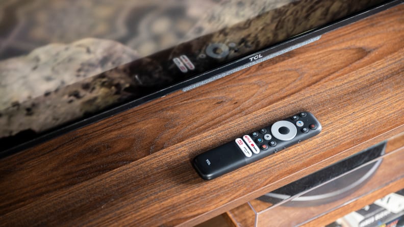 The TCL 5-Series with Google TV sitting on a tabletop next to its remote control