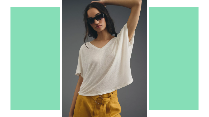 A model wears an airy white T-shirt and mustard pants.