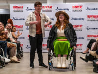 Two disabled people on runway showcasing clothes.