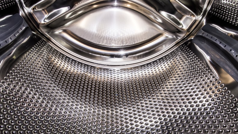 The drum is lined with textured steel to scrub clothes without tearing them.