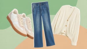 A pair of white shoes, blue jeans, and a white cardigan on a green and orange background.