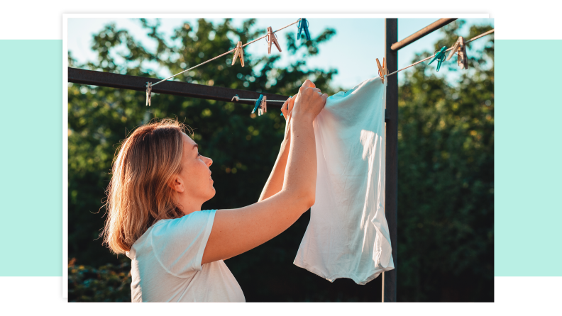 A person hanging linens to dry outdoors