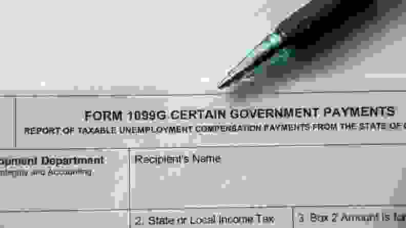 Form 1099-G on table next to pen