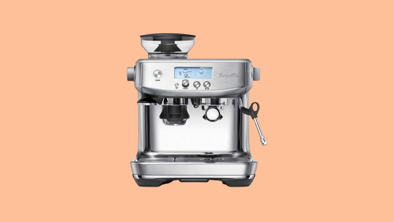 A Breville Barista pro sitting against a light orange background.