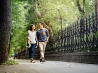 man and woman walk on pavement