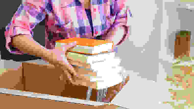 Woman taking books from a box