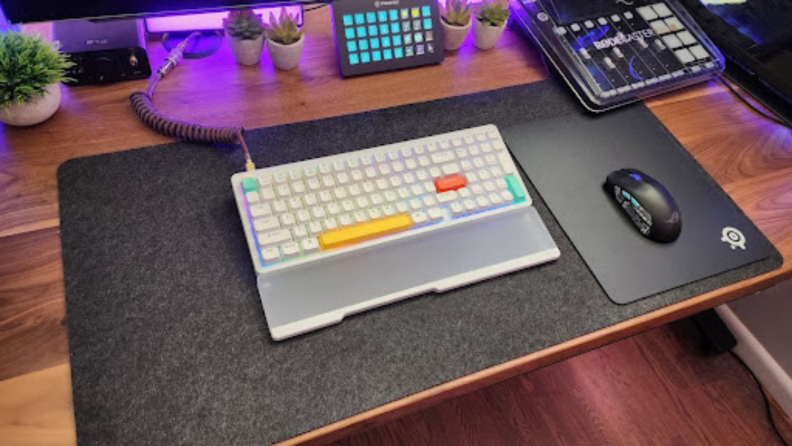 Wide-view shot of the Nuphy Halo96 on a desk with an adjacent mouse on mousepad.