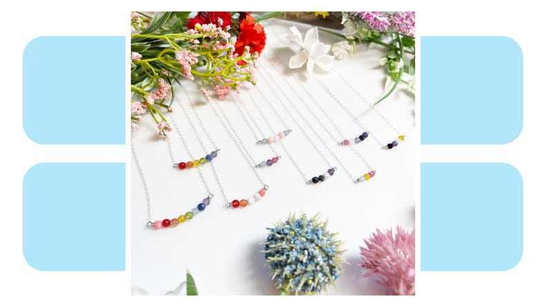 Simple chain necklaces with beads in Pride colors.