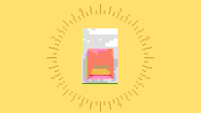 A bag of decaf coffee against a bright yellow background.