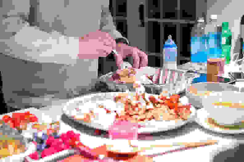 A man is putting away leftovers from a Thanksgiving day feast.  RM