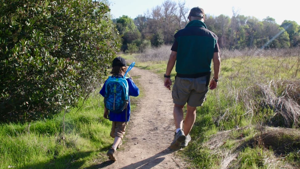 Young boy hiking with his grandfather.