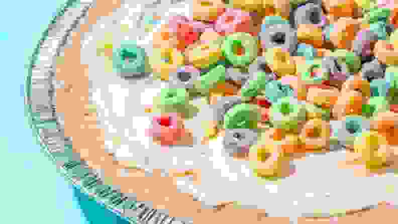 A closeup image of Cereal Killer Pie, showcasing the cream cheese pie base and Froot Loop cereal topping.