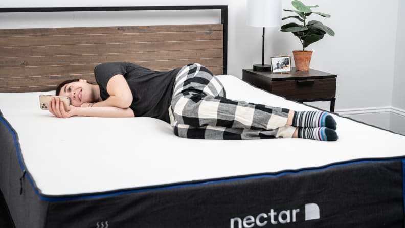 woman lying on side on bed