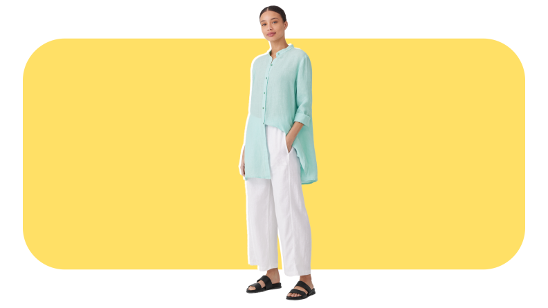 Model wearing white linen pants and teal button-down shirt.
