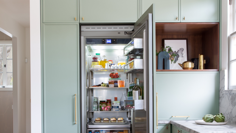 A column fridge open in a kitchen setting