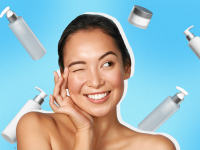 Person smiling while using two fingers to rub products into skin while surrounded by moisturizer bottles.