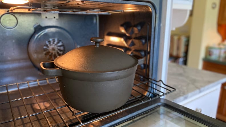 Inside an KitchenAid oven, there's a Perfect Pot in char (black) on the lower rack.