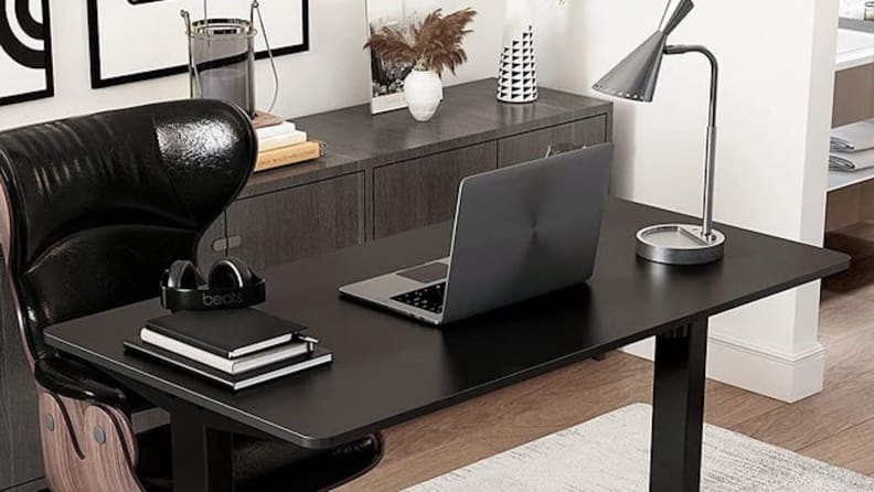 Image of desk with laptop and books on it