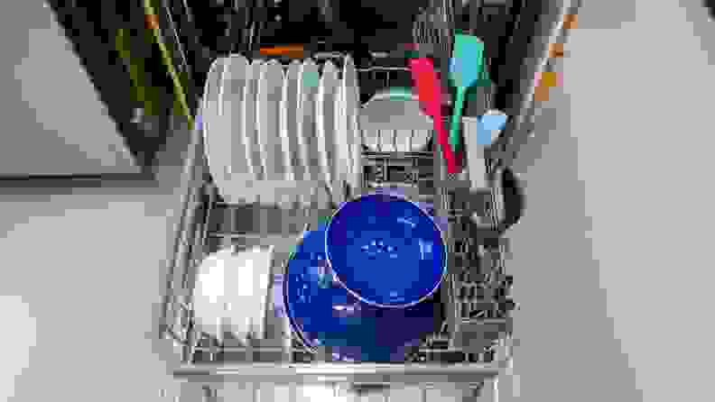 Plates, colander, bowls and kitchen utensils sitting on lower rack of LG LDTH7972S dishwasher.