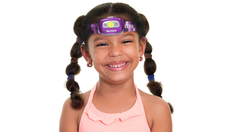 A young child wears a headlamp.